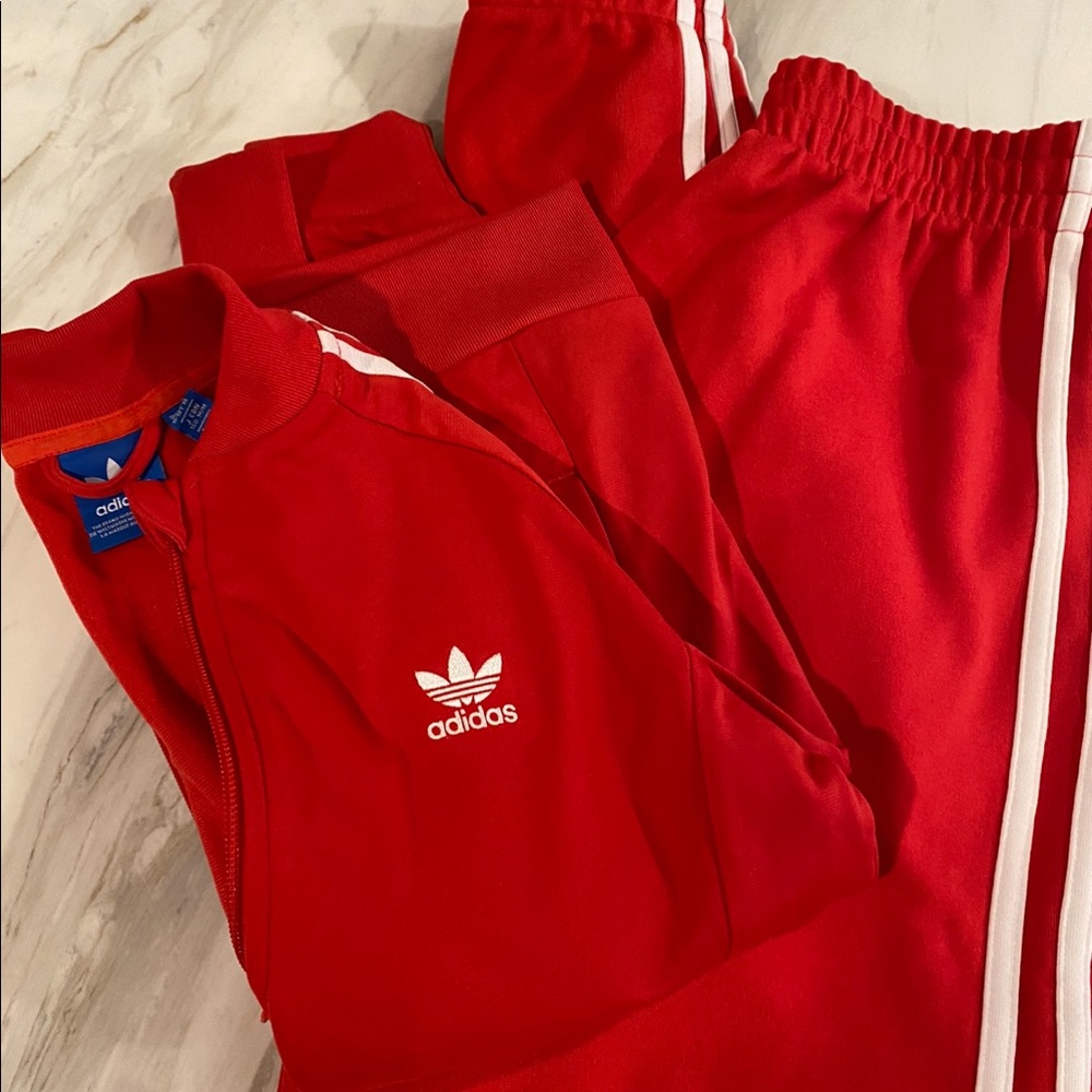 Adidas red track suit.